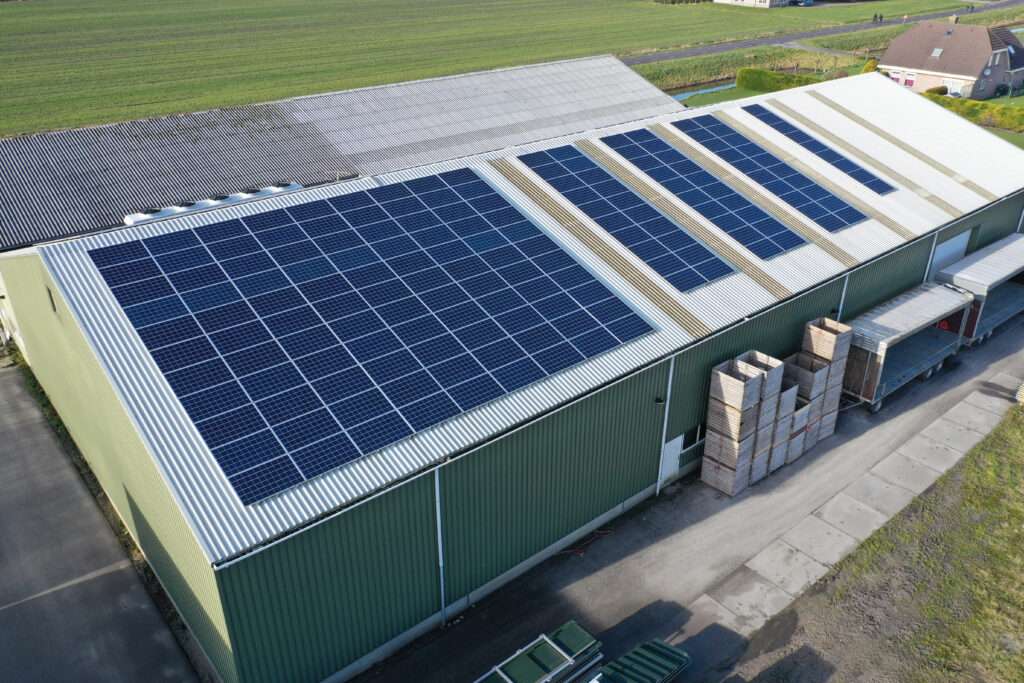 Solar panels on the roof of a manufacturing plant building.